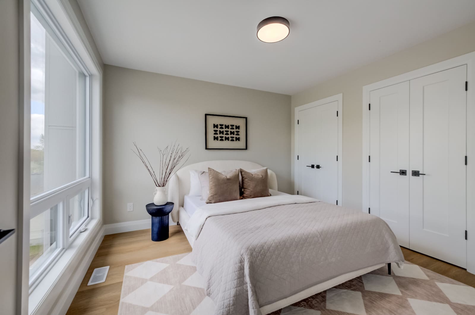 Bright bedroom interior at Haravale Towns with wide-plank flooring and natural light